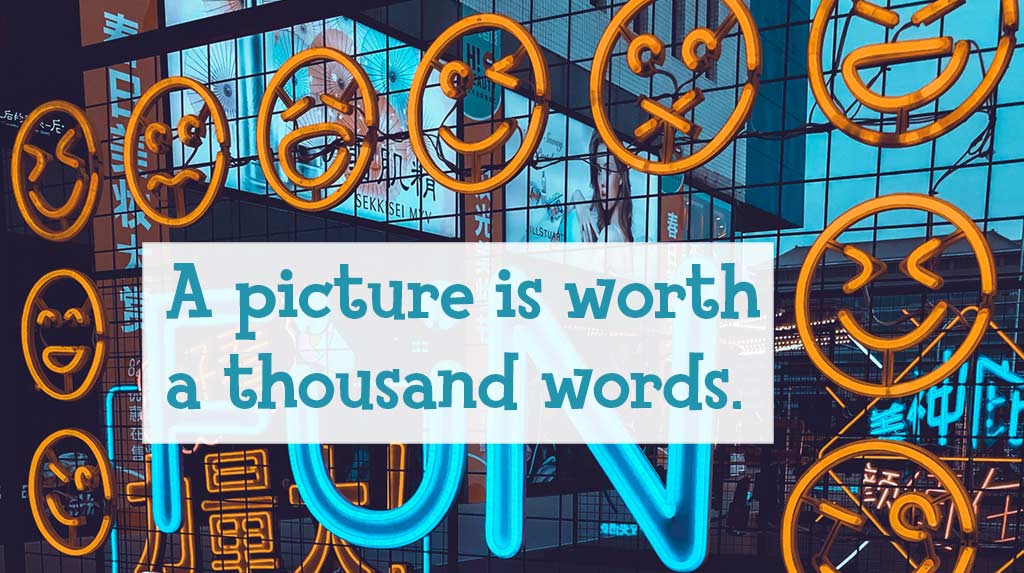 Neon sign with emojis & "A picture is worth a thousand words."