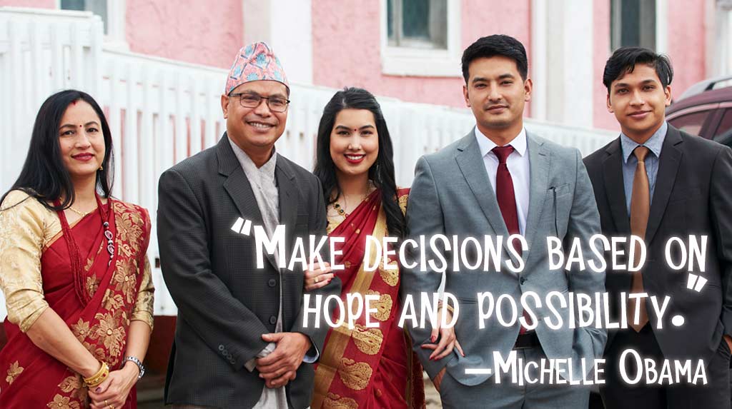 South Asian family smiling at camera