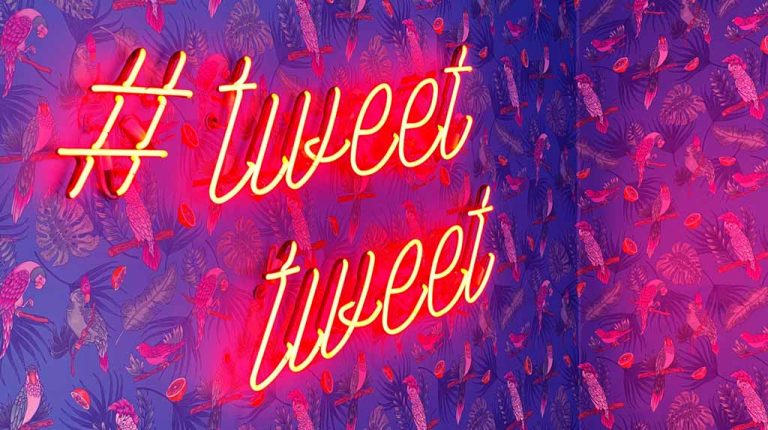 Neon lighting that reads "#tweet tweet"