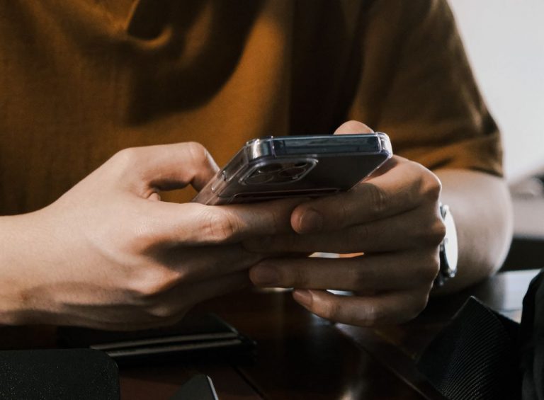 A person texts on a smartphone.