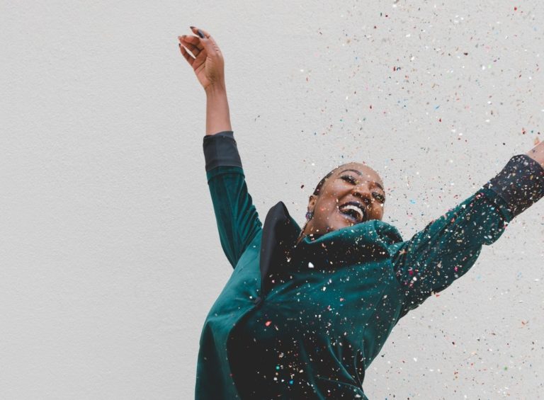 A woman jumps for joy.