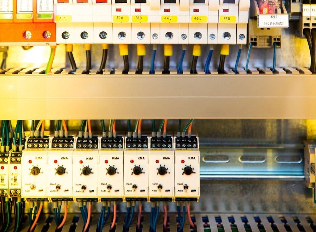 An electric switch box with many neatly arranged wires.