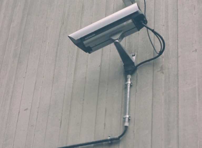 A security camera mounted on a wall.