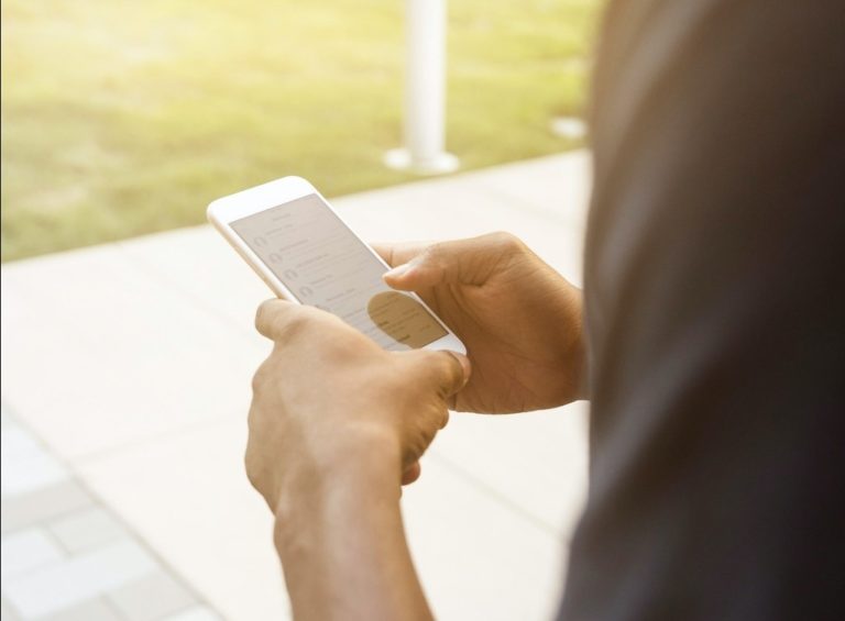 A smartphone in a man's hands.