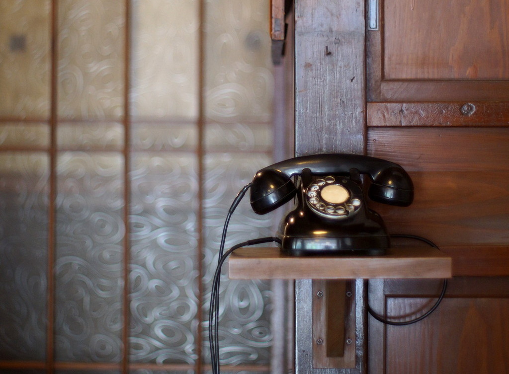 An old-school rotary dial telephone.